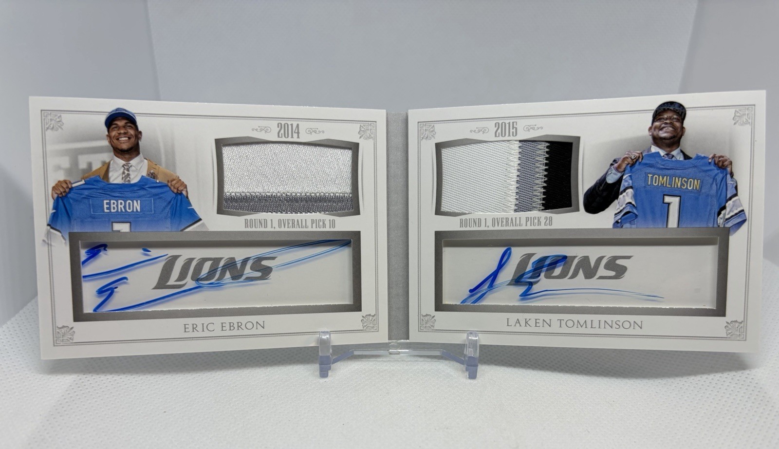 ERIC EBRON / LAKEN TOMLINSON 2015 National Treasures RC AUTO BOOKLET Lions /10