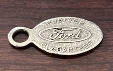 This is a Vintage Ford Postage Guaranteed Keychain Fob. Made In USA