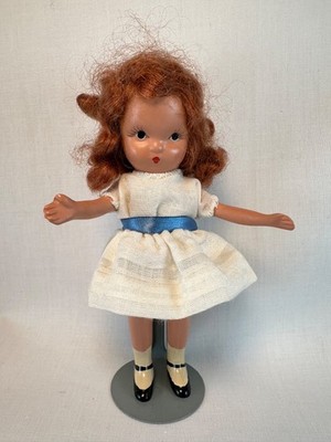 Vintage Bisque Redhead Storybook Doll with stand. Jointed arms, solid legs. 
