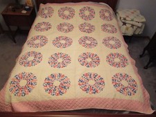 Vintage handmade quilt pieced quilted 20 petal flowers 66 x 80 on queen bed