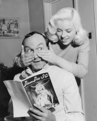 Diana Dors surprises actor Maurice Denham who is reading the Diana- Old Photo