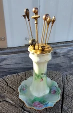 Vintage Porcelain hat pin holder with 11 brass/gold colored hat pins