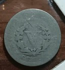 Worn silver 1910 Liberty Head V nickel with visible scratches and embossed text “LIBERTY” and “IN GOD WE TRUST.”