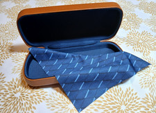 Official Fossil hard ,brown leather clamshell eyeglass case, and cleaning cloth.