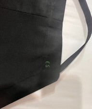 Apron made of black thick twill with big cargo pocket and adjustable neckline