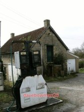 PHOTO  SORRY NO PETROL. OLD PETROL PUMPS OUTSIDE A VERY OLD BUILDING POSSIBLY A