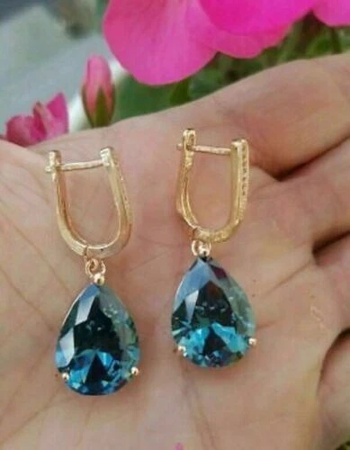 Pendientes colgantes/gotas solitario topacio azul corte pera de 4 quilates acabado oro amarillo de 14 quilates Foto 2 de 4