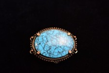 vintage 2 inch turquoise belt buckle with a metal frame