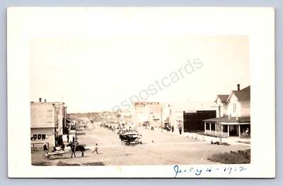 K10/ Arco Idaho RPPC Postcard c1910 July 4th Parade Scene Patriotic Stores 266