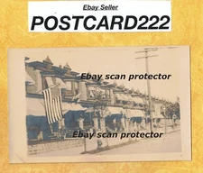 X RPPC Houses 1908-39 RPPC POSTCARD ROW HOUSES WITH AMERICAN FLAGS #63UKN
