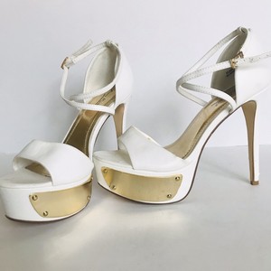 white heels with gold accents