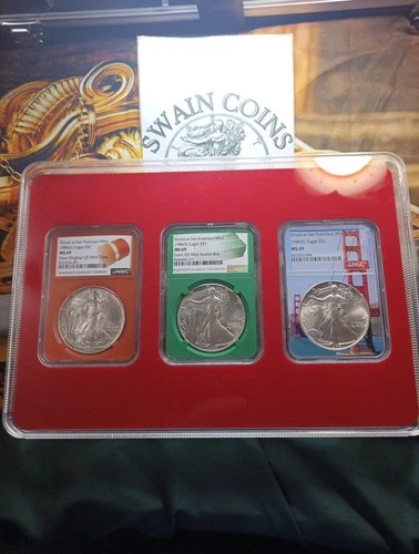 1986 (S) American Silver Eagle  NGC MS69 Orange Core, Green,  Bridge Core.  Set.