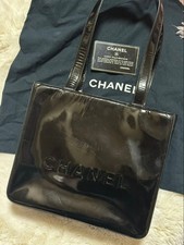 CHANEL Shoulder Bag Patent Leather Black 21x24x7 cm Logo Embossed Front