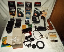 VTG. CAMERA PARTS LOT LENSES, FLASH UNITS, STRAPS, CAMERA BROCHURES ETC... READ!