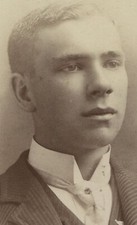 YOUNG MAN IN STRIPED SUIT, HIGH COLLAR. CABINET CARD.