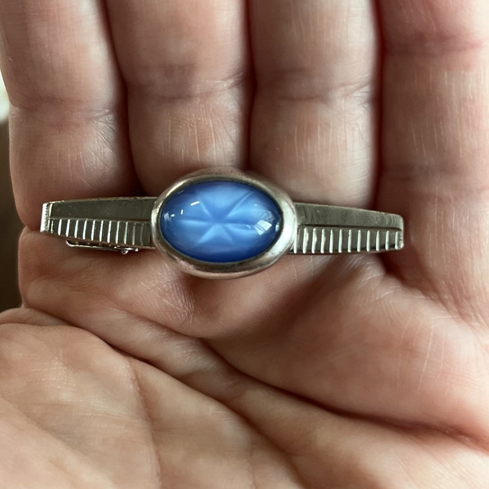A cat-eye silhouette on a tie clip is genuinely rare — this Anson piece is a tiny wearable sculpture that turns a boring suit into a conversation starter.