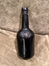 1800s English Black Glass Wine Bottle With Raised Merchant Seal