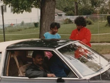 1980s Black Family Car Driveway Conversation Outside Suburban Home