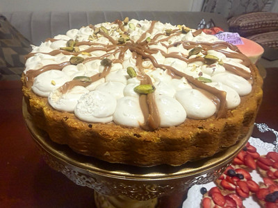 Round Cake & Tart with Whipped Topping, Chocolate Drizzle & Pistachio Garnish