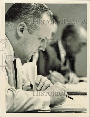 1962 Press Photo Charles M. Lowe reviews documents during meeting - lrb25237