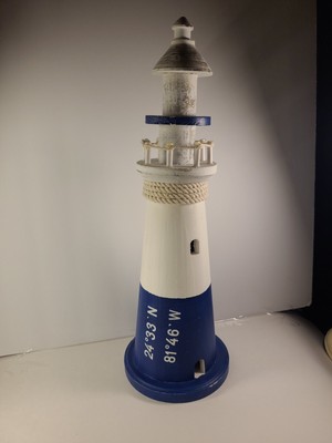 Blue and white 16'' wood lighthouse made for beach comers life Ft. Walton FL.