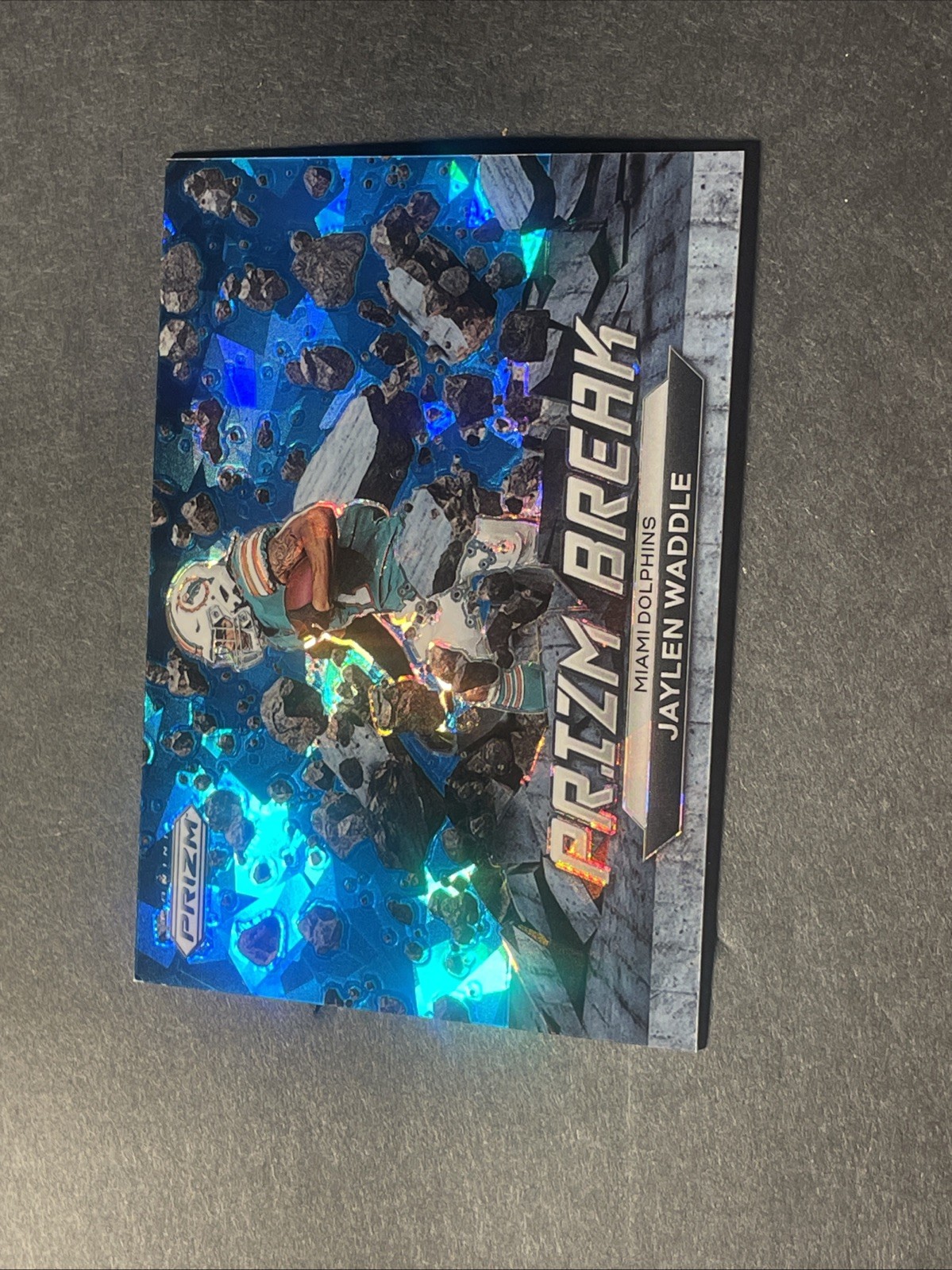 2022 Panini Prizm Jaylen Waddle Prizm Break Blue Cracked Ice /99 Dolphins