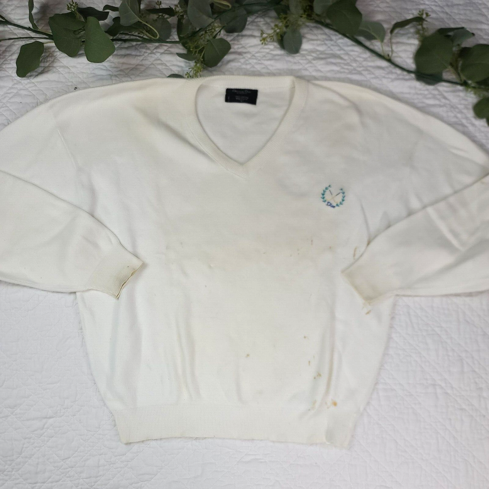 White VTG Christian Dior men’s V-neck sweater with blue monogram and laurel wreath logo on chest, made in USA.