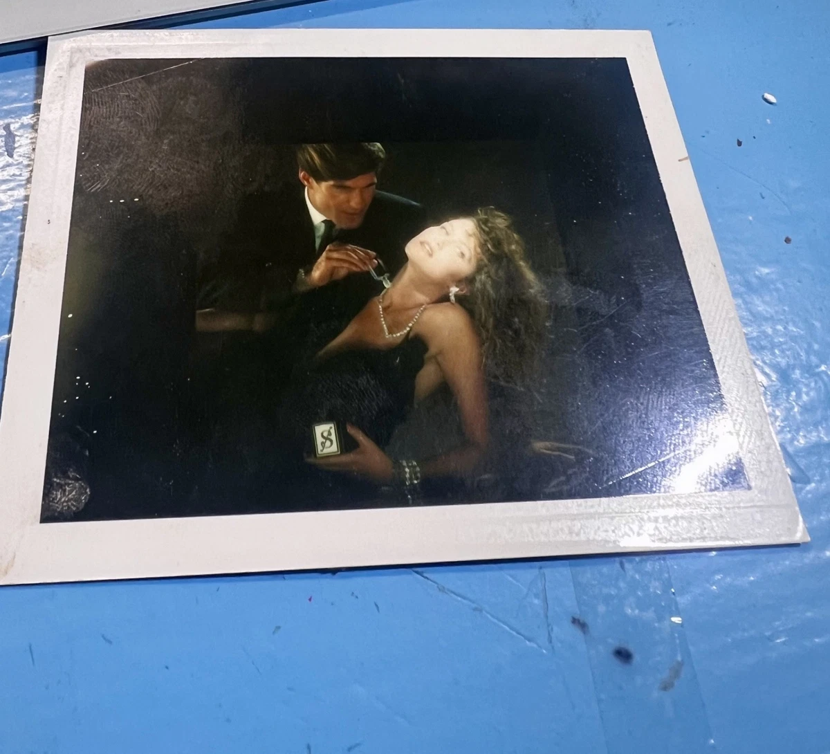 An Old Vintage Polaroid Camera Is Sitting On A Table Background