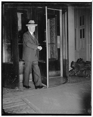 Photo:1939 1940 Man in Suit Hat Exits Building Revolving Door Interior