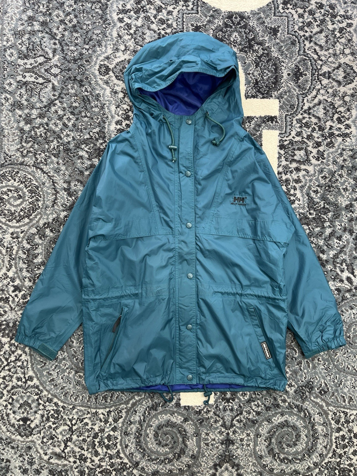 Chaqueta cortavientos Helly Hanson HH empacable con capucha azul verdoso cremallera completa talla L