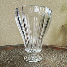 hurricane candle holder featuring a flared rim and a faceted pedestal base.