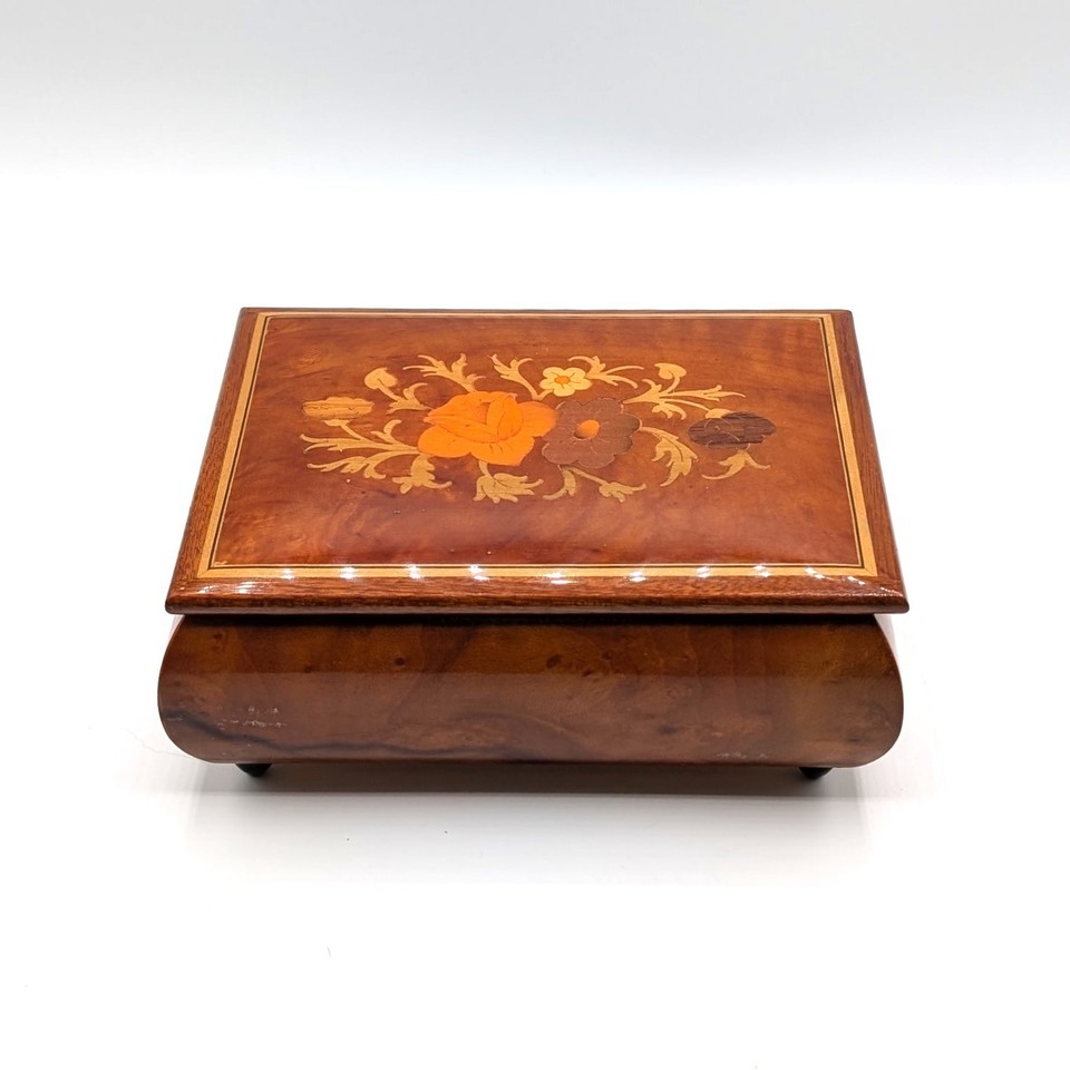 A Swiss-made Reuge jewelry box with Italian floral inlay playing 'Fascination' — the kind of heirloom piece that makes people stop and ask where you got it.