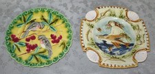 TWO ANTIQUE MAJOLICA PLATES ONE WITH BIRDS CHERRIES AND ONE WITH A MERMAID