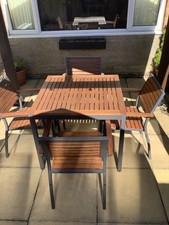 SOLID HARDWOOD AND METAL TABLE AND CHAIRS . NEW .