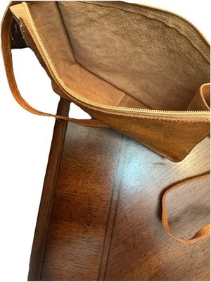 This is a brown leather crossbody bag by Il Bisonte