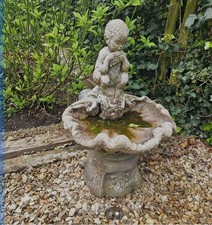 Beautiful Classical Cherub Playing Pipes. Shell Basin in stone . Approx 1m High.