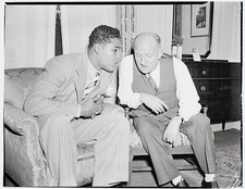 Heavyweight boxing champion Joe Louis talks with his fight promote- Old Photo