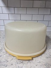 Vintage Tupperware round cake keeper carrier with yellow base and ivory lid.