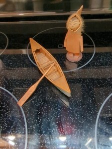 Small Wooden Canoe With Green Bottom and Eskimo figure