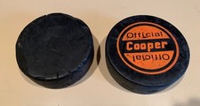 TWO (2) USED COOPER OFFICIAL HOCKEY PUCKS