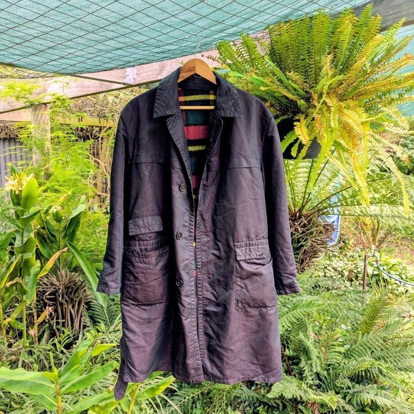Black vintage trench coat with plaid lining and a purple sheen