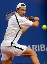 Nicolas Kiefer of Germany plays a backhand v Gaston Gaudio of Arge- Old Photo