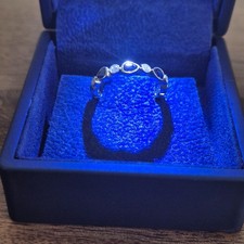 18ct white gold eternity ring with  diamonds and a pear-shaped sapphires