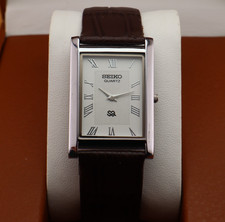 Vintage Seiko Slim Quartz Men's Wrist Watch White Dial with Dark Brown Strap.