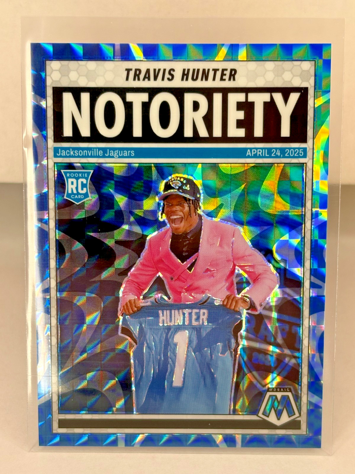 2025 Panini Mosaic Notoriety Travis Hunter #12 Blue 28/99