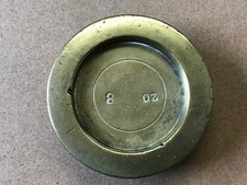 old brass 8 oz weight . nice patina  ( lead filled  ? )