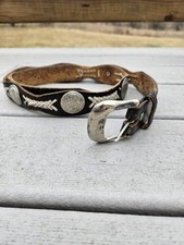 vintage Western black and brown leather concho belt with white braided lacing...