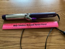 Conair curling iron, purple.preowned in working condition. 60 in cord intact.