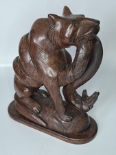 JAPANESE HARDWOOD SCULPTURE OF TIGER BATTLING WITH A BOA CONSTRICTOR SNAKE.