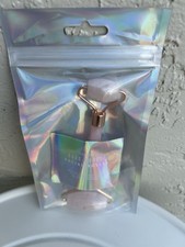 rose quartz facial massage roller.